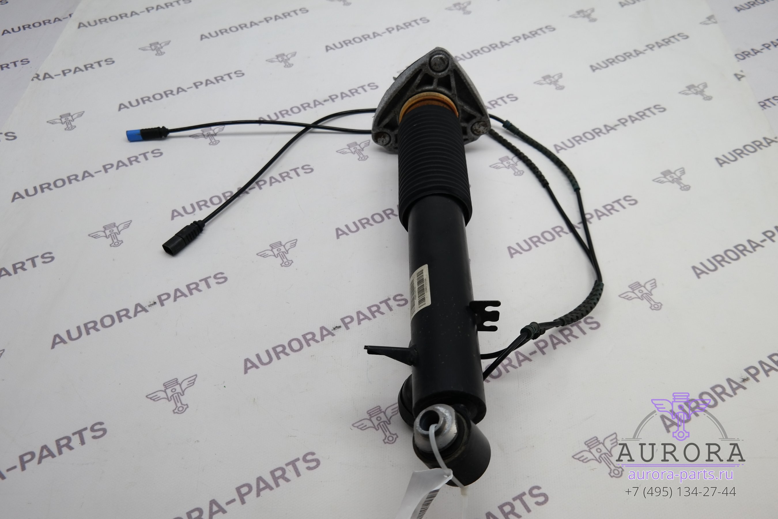 Амортизатор задней подвески в сборе с опорой левый